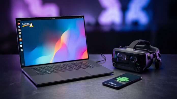 Laptop con Linux, visor de realidad virtual y teléfono con el logo de Android sobre un escritorio